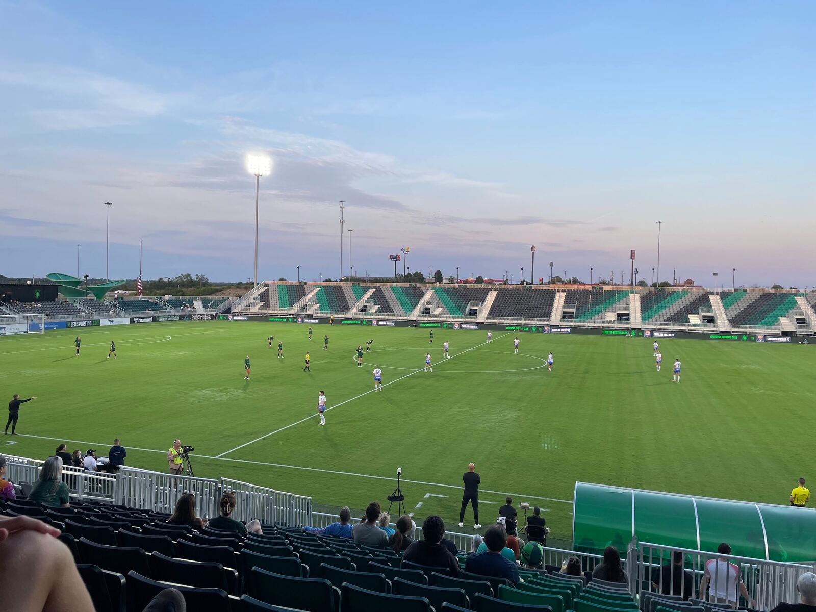 Women's professional soccer match at dusk