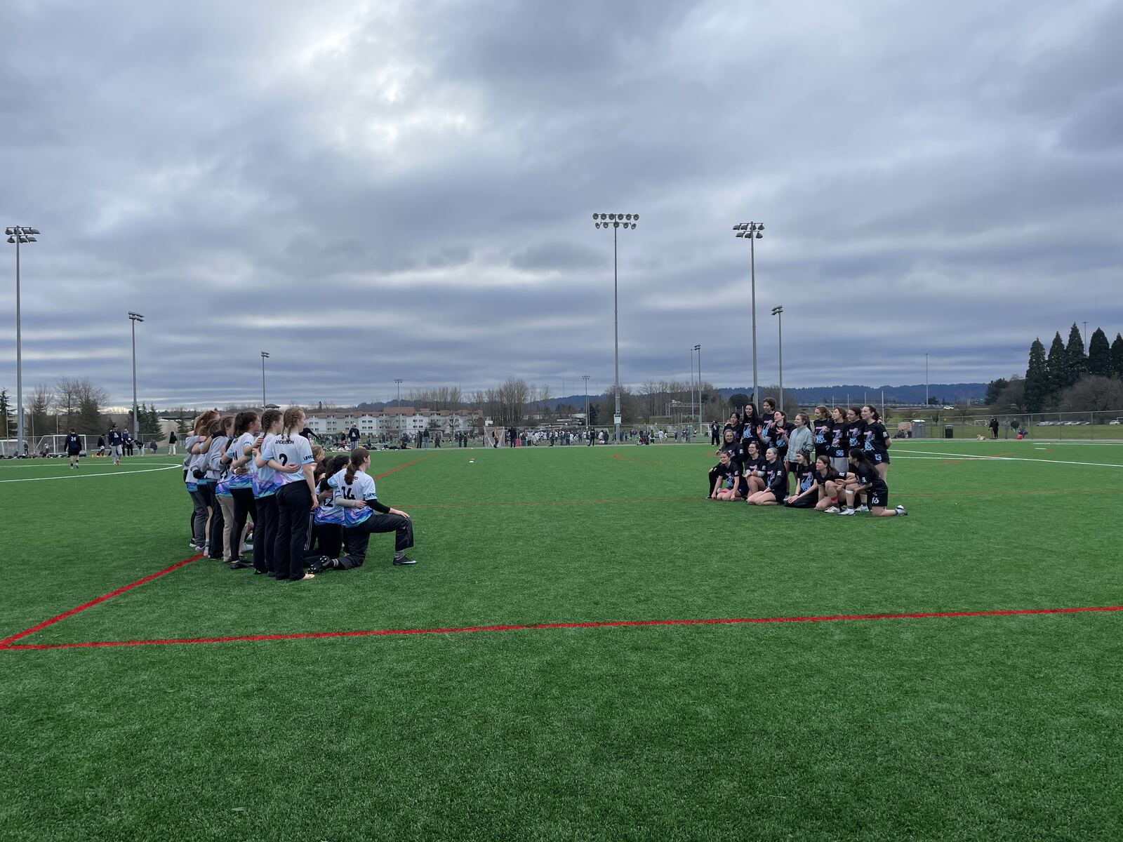 Two teams lined up facing each other before a match