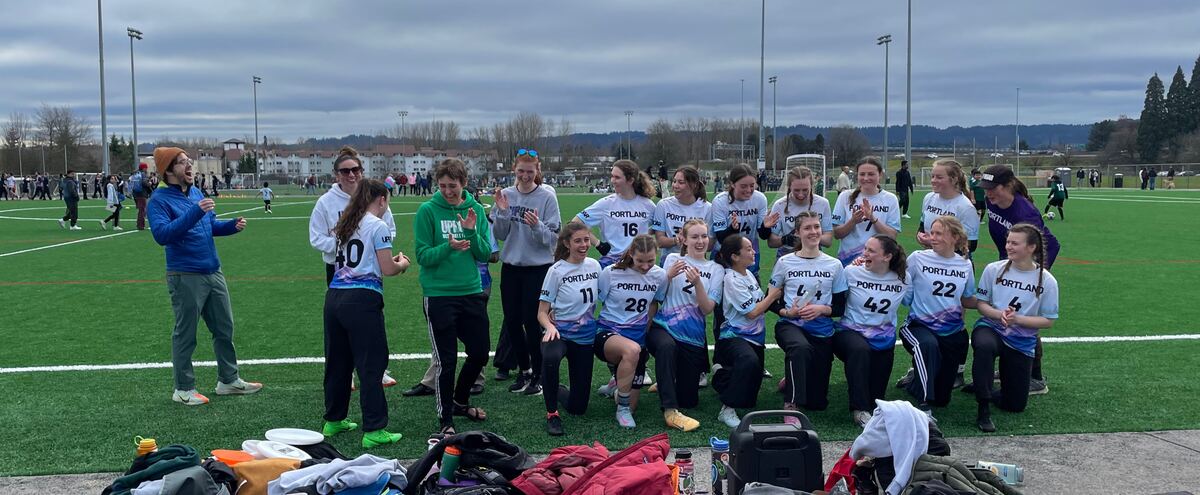 Cara celebrating with her ultimate frisbee team after a win